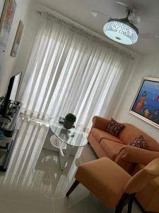 a living room with a glass table in front of a window at Apartamento Cabrera II in Cabrera