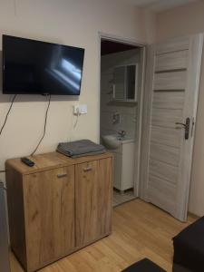 a room with a flat screen tv on the wall at Domki przy siłowni in Siechnice