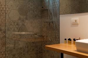 a bathroom with a shower and a counter with a sink at Apartments Eleganca in Dubrovnik +30 photos
