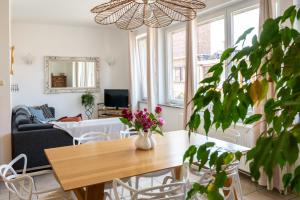 a living room with a table and a couch at Chez Marraine Suzanne in Liège