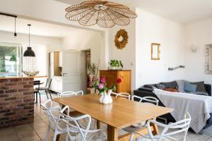 a living room with a table and a couch at Chez Marraine Suzanne in Liège