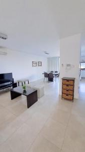 a living room with a couch and a table at Carilo - semipiso 3 ambientes in Carilo +24 photos