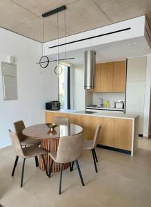 a kitchen with a dining room table and chairs at Elysian Blue villa 3 in Paphos City