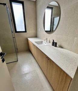 a bathroom with a sink and a mirror at Elysian Blue villa 3 in Paphos City