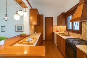 A kitchen or kitchenette at Paradise Found at Thalia's Poolside Villa