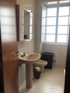 a bathroom with a sink and a toilet at Casa da Miniña in Quilmas +27 photos