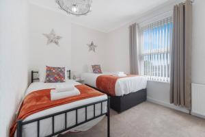 Voodi või voodid majutusasutuse Cosy 3BR in Coronation Terrace toas