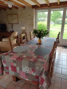 a table with a quilt on it in a room at Le gîte de battreau in Massognes +10 photos