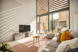 a living room with a couch and a tv at Villa Gold II in Fehmarn
