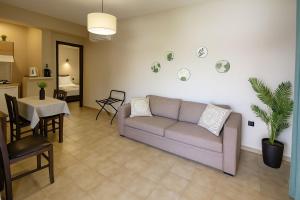 a living room with a couch and a table at Nicolas Beach in Palaiochora
