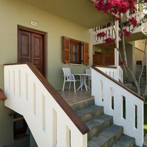 a staircase leading to a house with a table and flowers at Nicolas Beach in Palaiochora