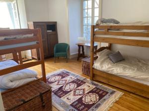 a room with two bunk beds and a table at Conciergerie du château in Gevingey +27 photos