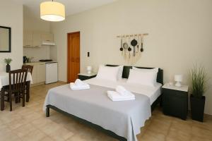 a bedroom with a large bed with two white towels at Nicolas Beach in Palaiochora