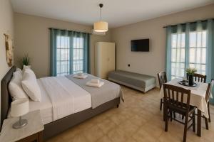 a bedroom with a bed and a table and a couch at Nicolas Beach in Palaiochora