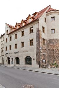 a large stone building on the side of a street at Hotel David an der Donau in Regensburg