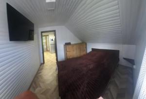 a room with a bed in a white wall at Садиба Оберіг 2 in Sheshory +3 photos