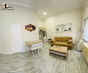 a living room with a couch and a table at Centrum Apartman Szerencs in Szerencs +2 photos