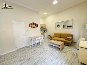 a living room with a couch and a table at Centrum Apartman Szerencs in Szerencs