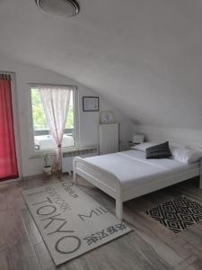 a bedroom with a white bed and a window at Holiday Home Casa Rondo in Bihać +39 photos