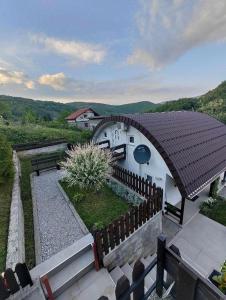 a house with a fence in front of it at Holiday Home Casa Rondo in Bihać