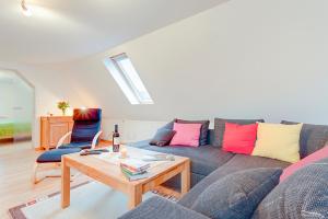 a living room with a couch and a table at Haushälfte Utecht & Jensen in Klein Warin