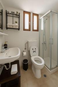 a bathroom with a toilet and a glass shower at Nicolas Beach in Palaiochora