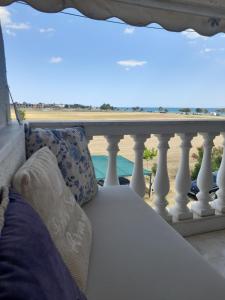 a couch on a balcony with a view of the beach at J&J Seaview Apartment in Ofrínion +6 photos