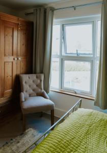 a bedroom with a chair and a window at Station House in Horsham