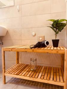 a wooden shelf with a potted plant on it at VillaDelphia in Kefallonia