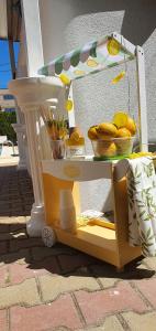 a cart with a bowl of fruit on it at Vila EPIC in Costinesti