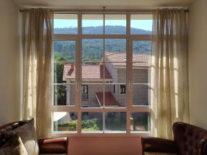 a large window with a view of a building at Casa do Poeta in Bubaces