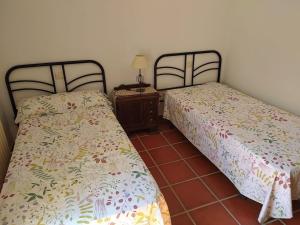 two beds sitting next to each other in a room at Casa do Poeta in Bubaces +13 photos