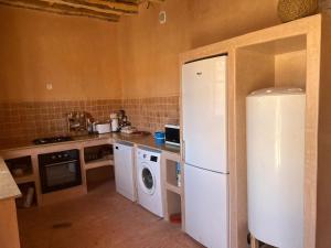 a kitchen with a refrigerator and a washer and dryer at Berberbayt lodge maison privé in Tinerhir +37 photos