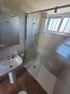 a bathroom with a shower and a sink at GRUPO GONTAD CASA CARMUCHA in Graña