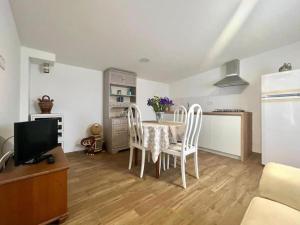 a kitchen and dining room with a table and chairs at GRUPO GONTAD CASA CARMUCHA in Graña +22 photos
