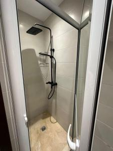 a shower with a glass door in a bathroom at براج رياحن in Tangier +2 photos