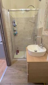 a bathroom with a sink and a shower with a glass door at VB Dream Homes - La Casetta sul Molo in Alassio