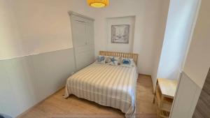 a bedroom with a bed with blue pillows on it at VB Dream Homes - La Casetta sul Molo in Alassio