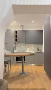 a kitchen with a wooden table in a room at VB Dream Homes - La Casetta sul Molo in Alassio