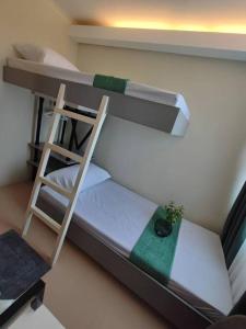 a scale model of a bunk bed with a ladder at Your home away from home in Piapi