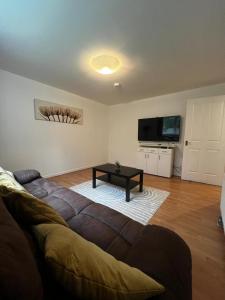 a living room with a couch and a coffee table at Lovely 2 bedroom Back Hilton near PJ Live in Aberdeen