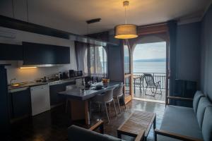 a kitchen and living room with a view of the ocean at Casa di Luca in Torri del Benaco