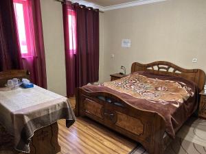 a bedroom with two beds and a table in it at Gokor Guesthouse in Dilijan