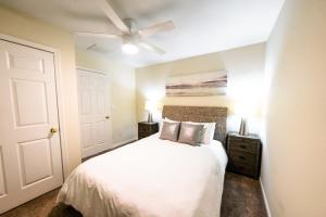 a bedroom with a white bed and a ceiling fan at Watermen's Cabana 2A - 3-Bed, 2-Bath Apartment - Walk To BEACH Access & PET Friendly! in Waves