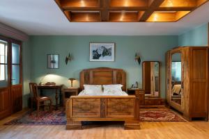a bedroom with a bed and a table and a mirror at Orlowska Townhouse Apartments in Kraków