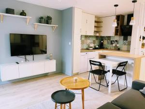 a kitchen and living room with a table and chairs at Jeannette's House in Magny-le-Hongre