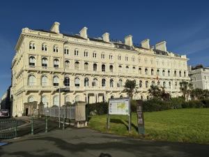 a large white building with a sign in front of it at 1 Bed - Napier by Pureserviced in Plymouth