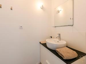 a white bathroom with a sink and a mirror at La Sérénade des Mauges Charme Nature Détente in Montfaucon +29 photos