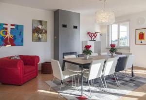 a dining room with a table and a red couch at Villa Bricco Astiani in Montegrosso dʼAsti +24 photos