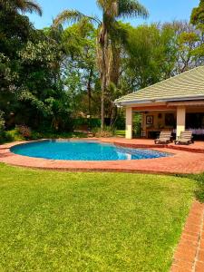 a swimming pool in the yard of a house at A boutique lodge situated in a serene environment - 2021 in Harare